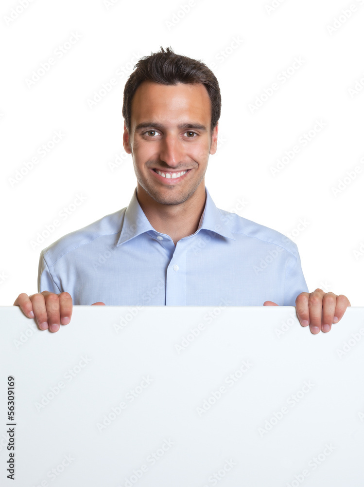 Smiling latin man with a signboard for advertising Smiling latin man with a signboard for advertising
