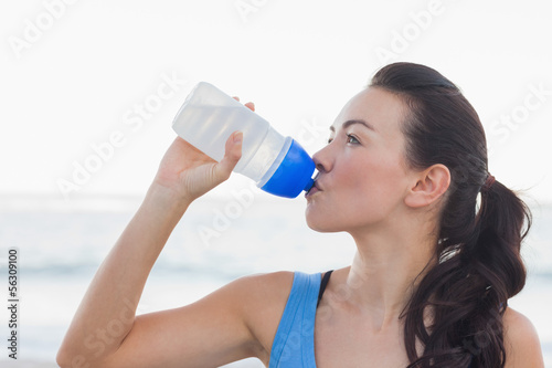 Woman drinking after exercising