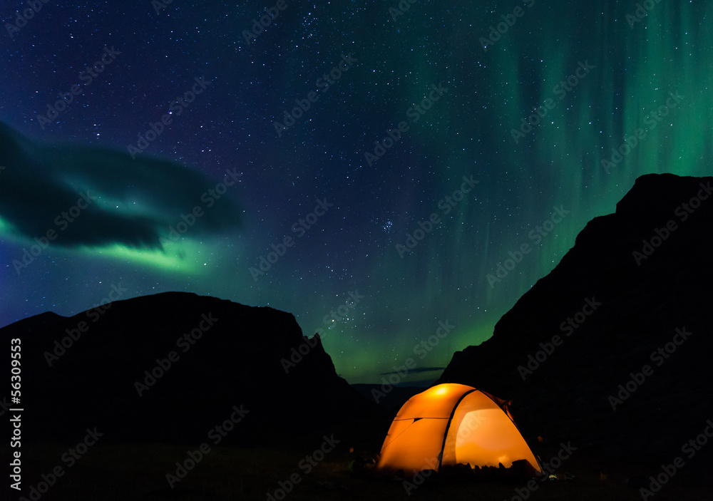 Illuminated Tent with northern lights in Lapland