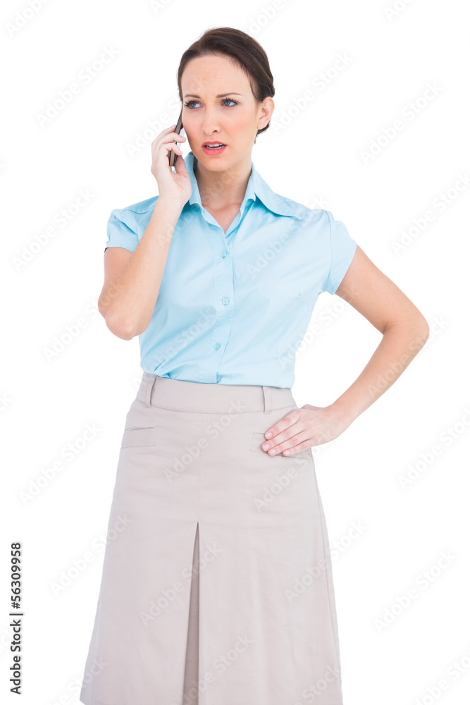 Serious classy young businesswoman on the phone Serious classy young businesswoman on the phone