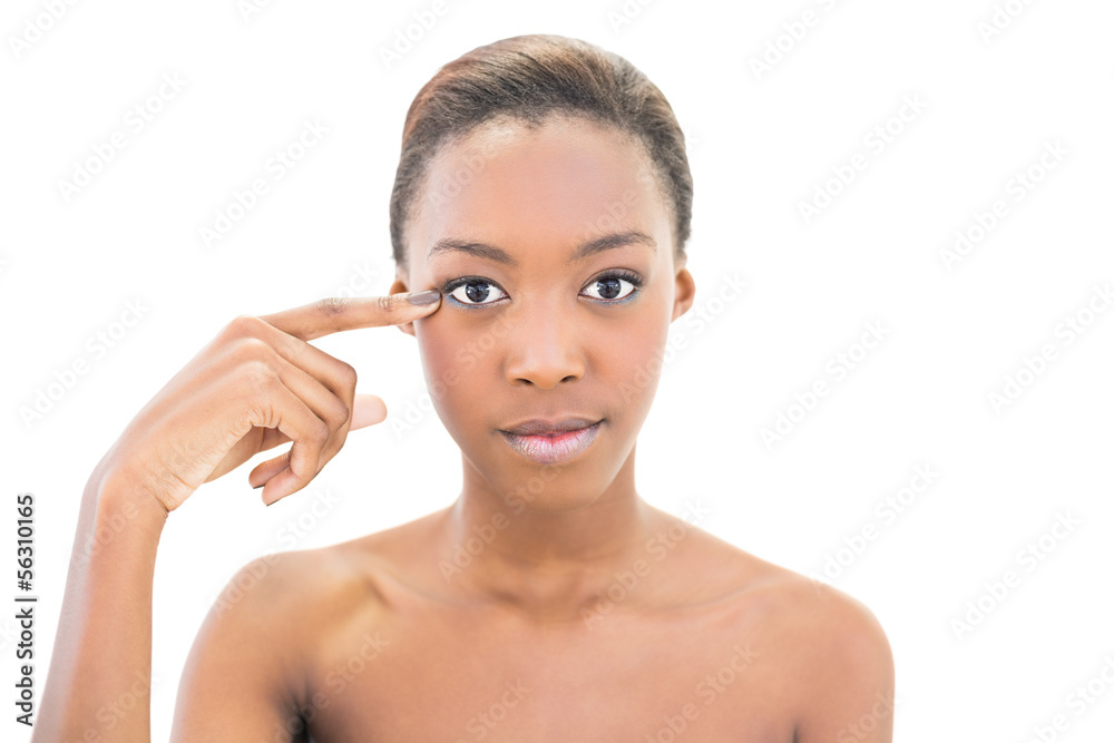 Peaceful natural beauty pointing at wrinkle on her eye Peaceful natural beauty pointing at wrinkle on her eye