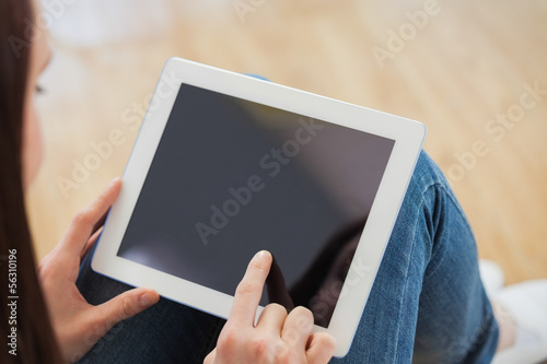 Teen using a tablet pc sitting on the floor