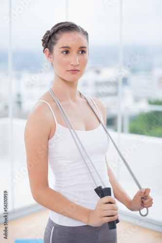 Pensive sporty woman holding skipping rope Free Download Pensive sporty woman holding skipping rope - GFXLoad