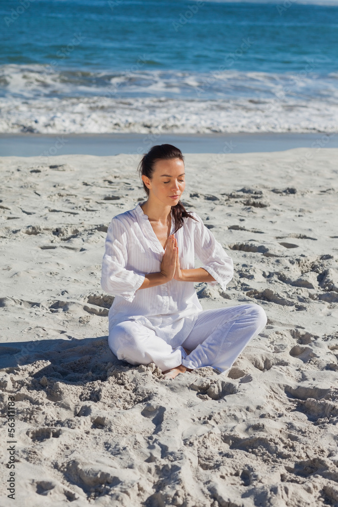Peaceful woman practicing yoga against the sea Peaceful woman practicing yoga against the sea