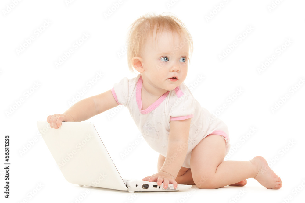 Cute baby with laptop on the white bed Cute baby with laptop on the white bed