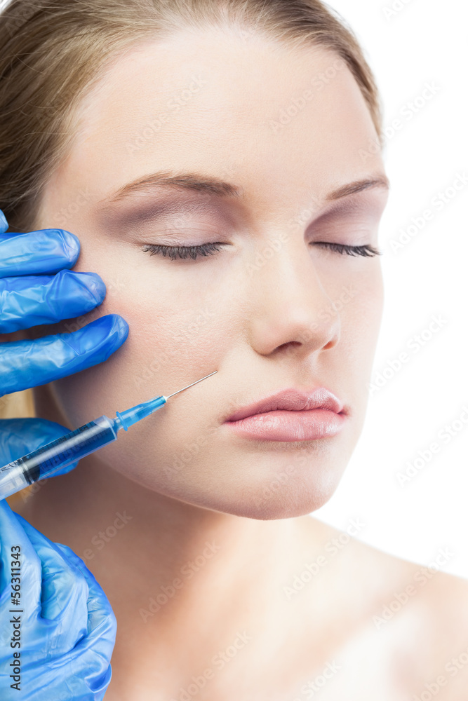 Relaxed gorgeous model having botox injection on the cheek Relaxed gorgeous model having botox injection on the cheek