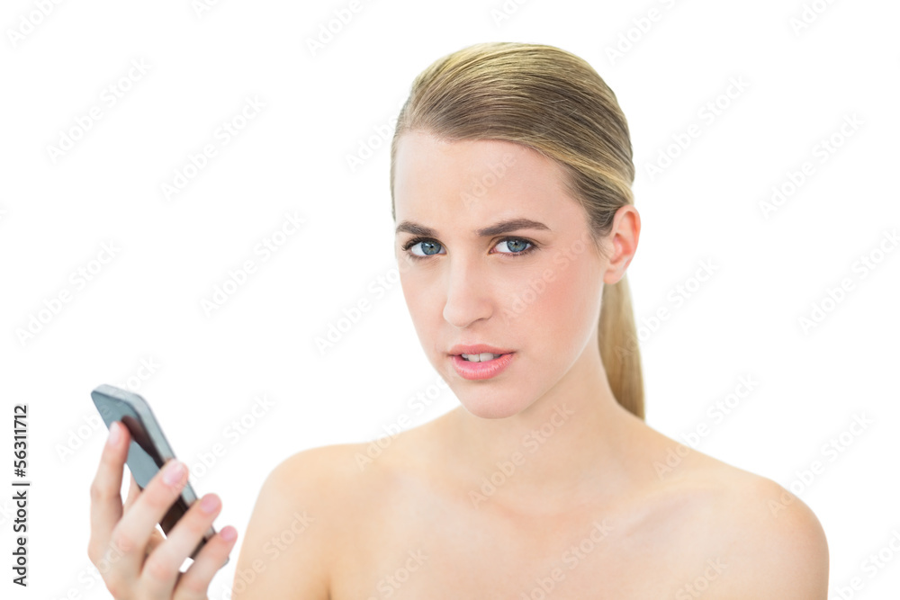 Serious attractive blonde holding her smartphone Serious attractive blonde holding her smartphone
