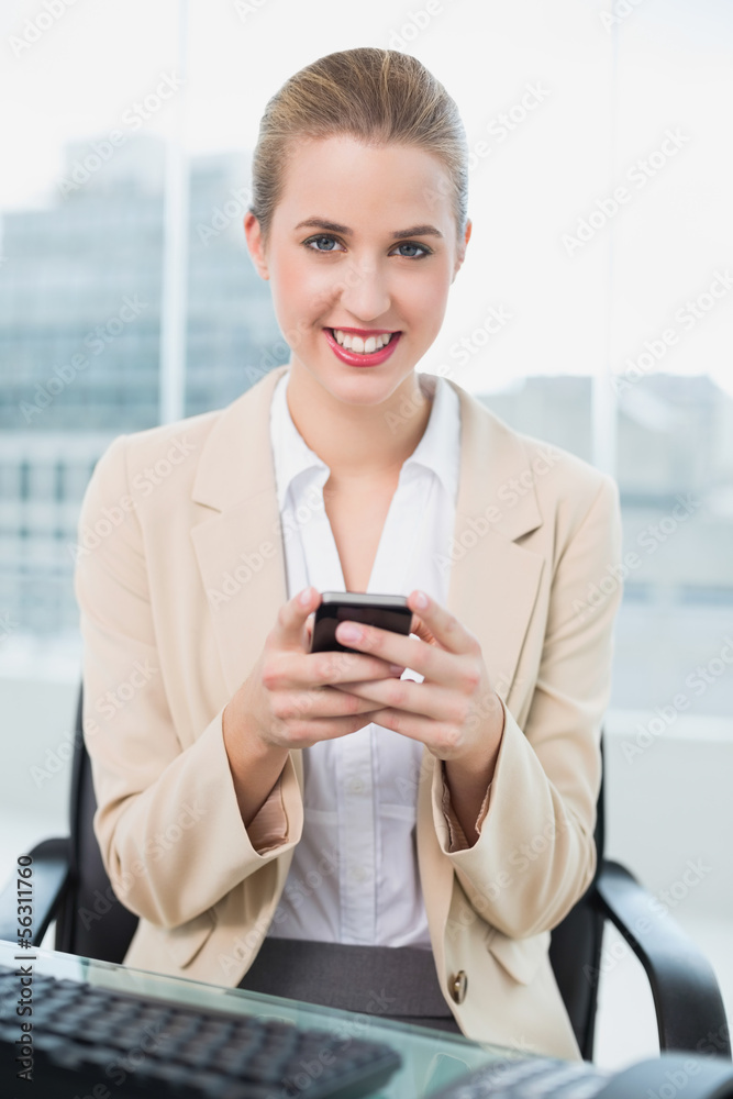 Cheerful attractive businesswoman text messaging Cheerful attractive businesswoman text messaging