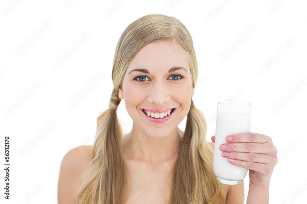 Delighted young blonde woman holding a glass of milk Delighted young blonde woman holding a glass of milk