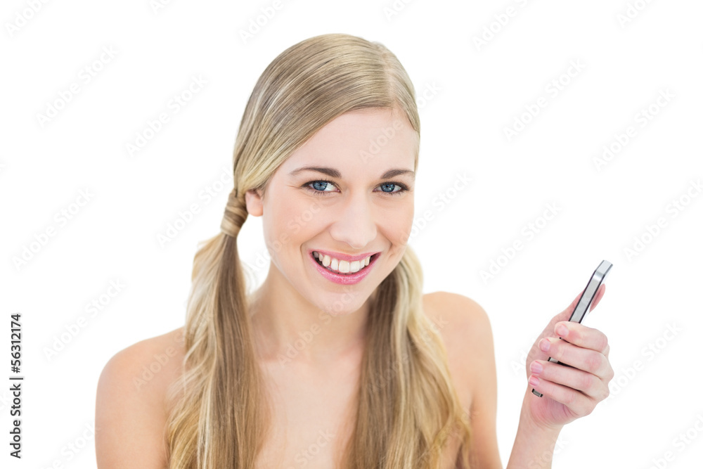 Pleased young blonde woman holding a mobile phone Pleased young blonde woman holding a mobile phone