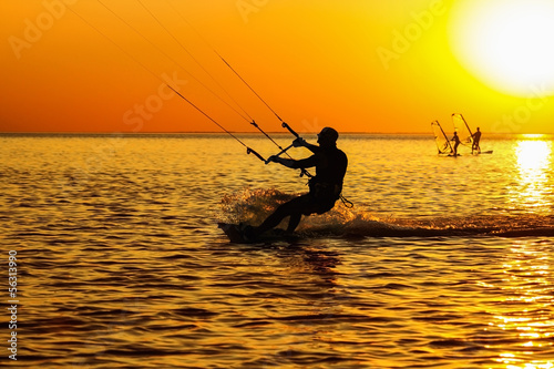 Silhouettes of a windsurfers