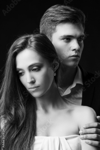 Depressed couple. Black and white image of sad young couple in f