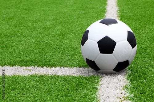 Soccer ball point on field at side line © krissada