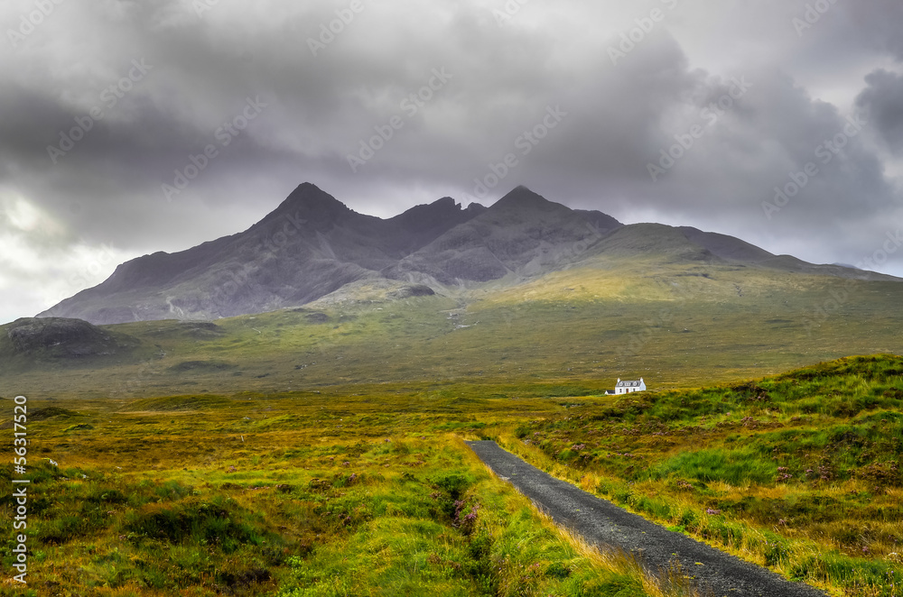 Cuillin Hills mountains with lonely house and road, Scotland
