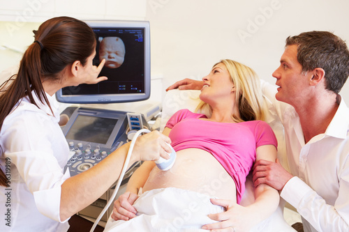 Pregnant Woman And Partner Having 4D Ultrasound Scan photo