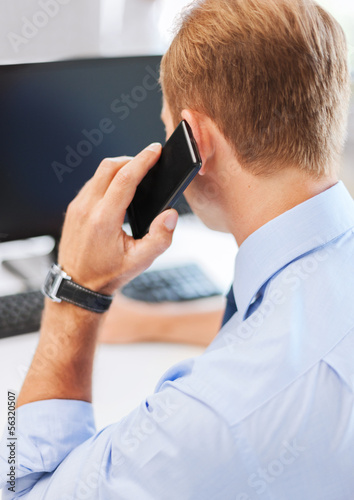 businessman with smartphone in office