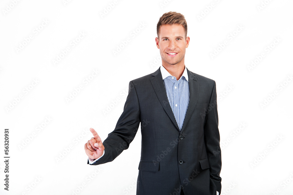 Businessman pressing an imaginary button on bokeh Businessman pressing an imaginary button on bokeh