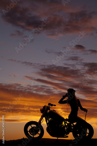silhouette of woman motorcycle sit backwards hand