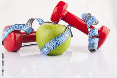 Apple, measurement tape and dumbbell 3