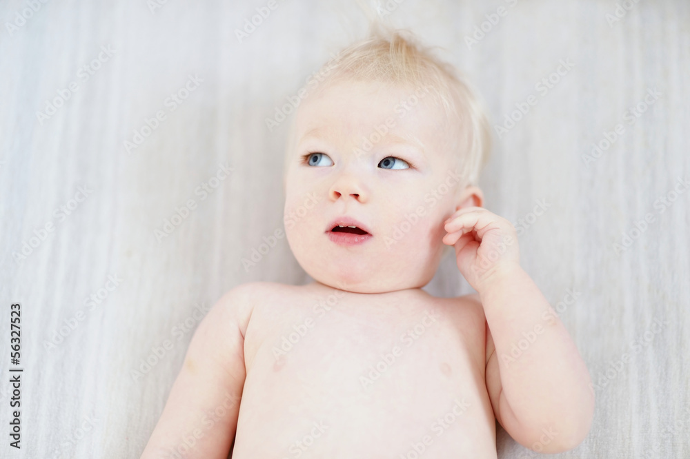 Adorable girl portrait on a white blanket Adorable girl portrait on a white blanket