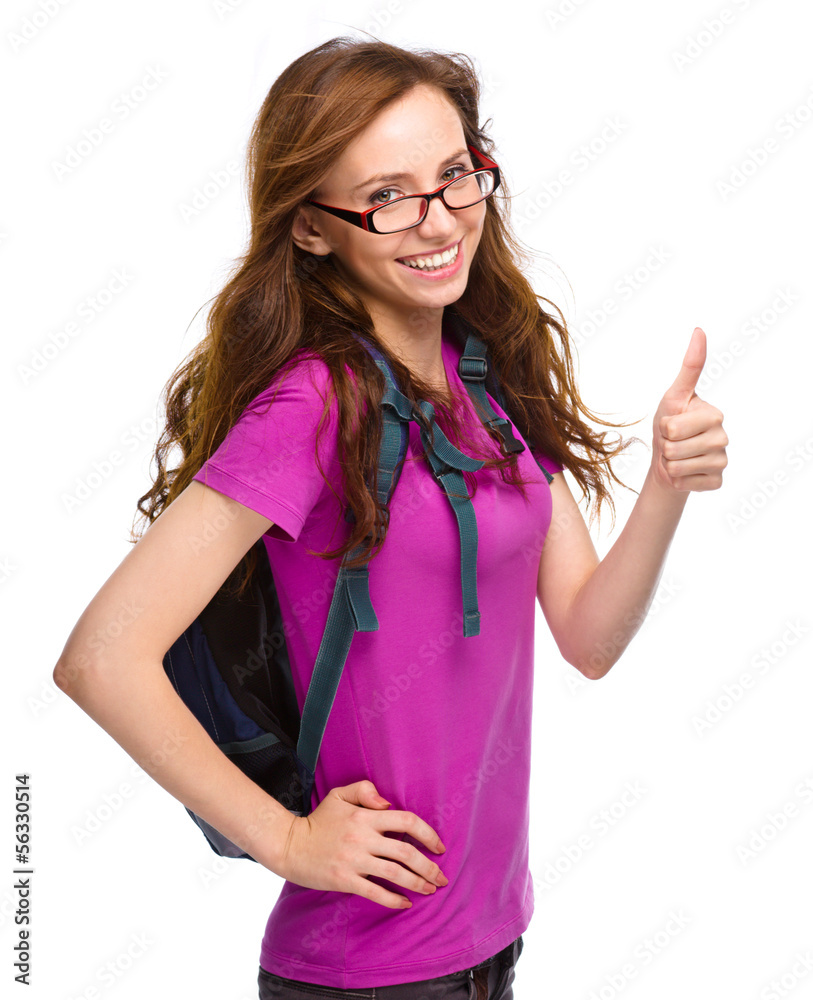 Young student girl is showing thumb up sign Young student girl is showing thumb up sign