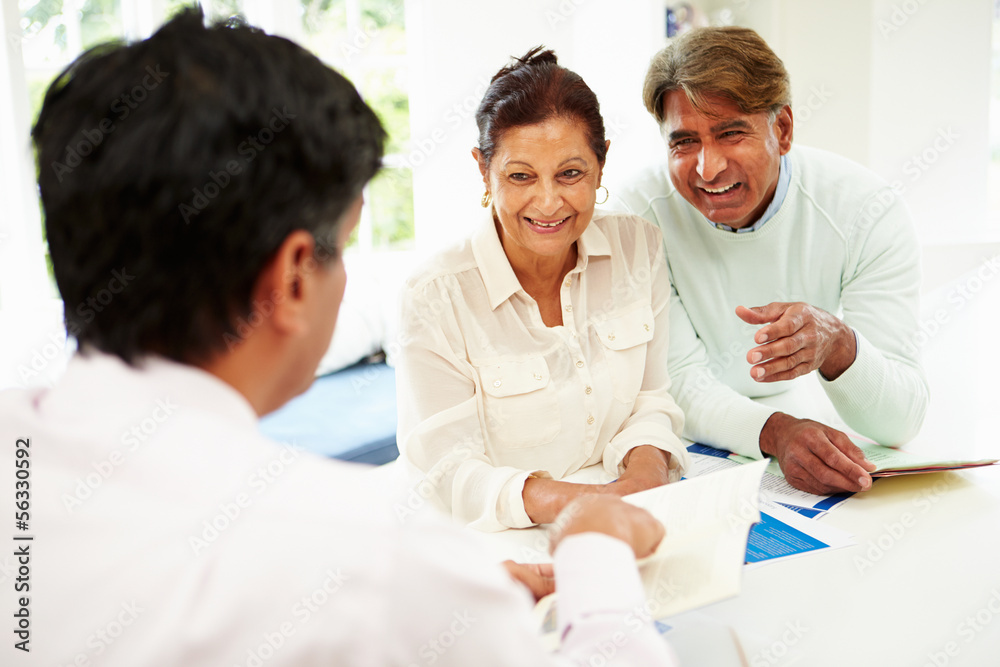 Senior Indian Couple Meeting With Financial Advisor At Home Senior Indian Couple Meeting With Financial Advisor At Home