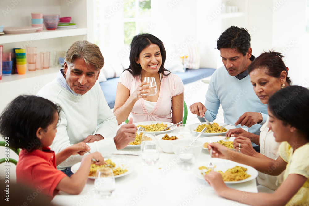 Multi Generation Indian Family Eating Meal At Home Multi Generation Indian Family Eating Meal At Home