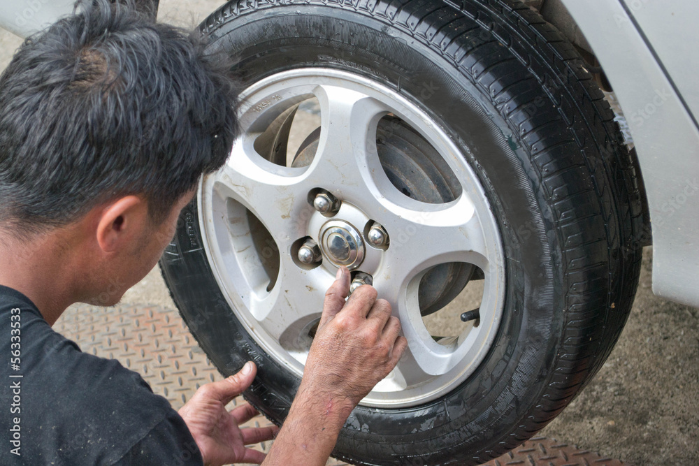 Auto mechanic changing car wheel Auto mechanic changing car wheel