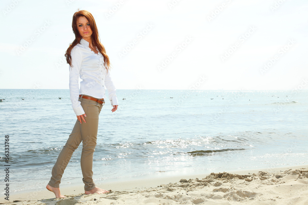 The young happy woman on a beach