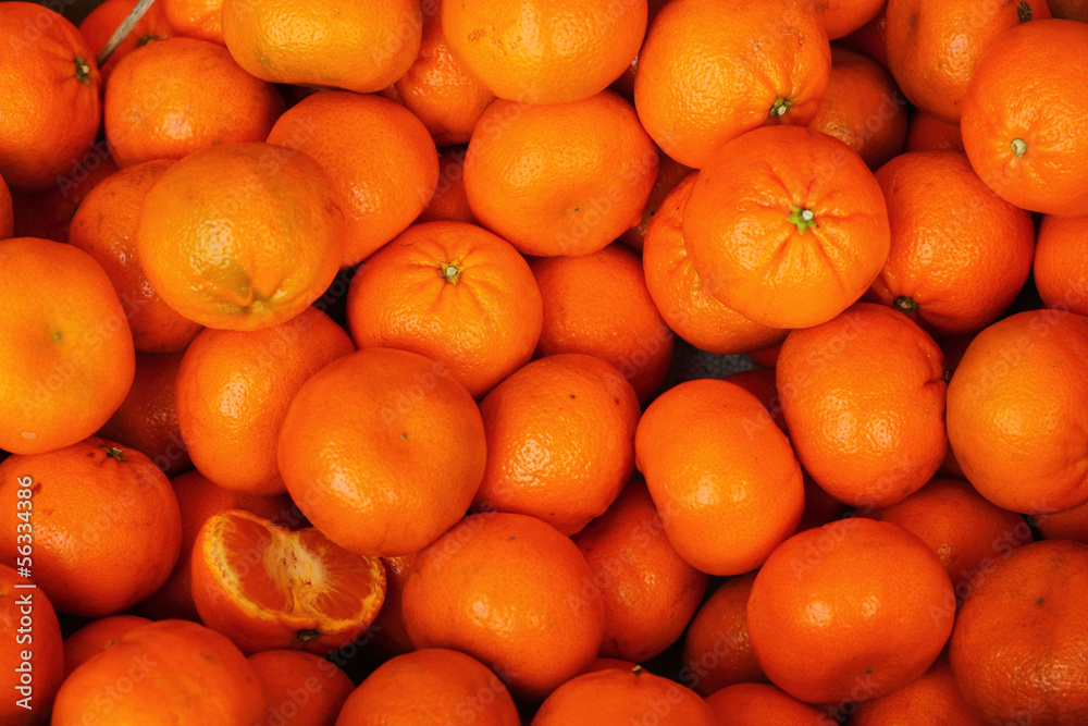 Orange fruit is the background.