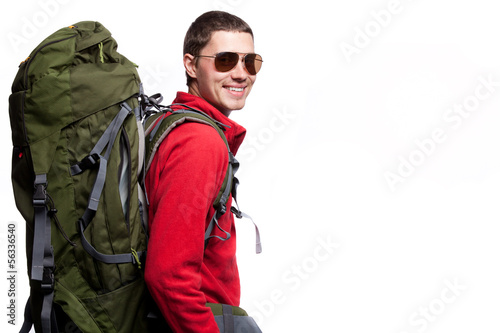 Hiker with backpack standing at white background