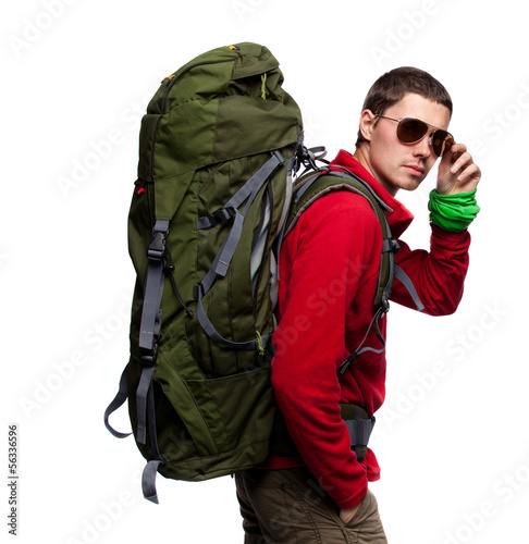 Hiker with backpack standing at white background