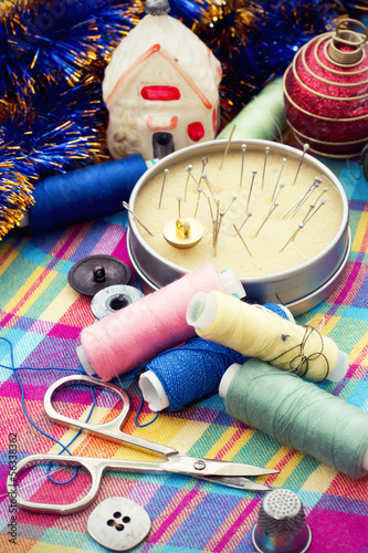 box of thread and needles and Christmas tree decorations photo