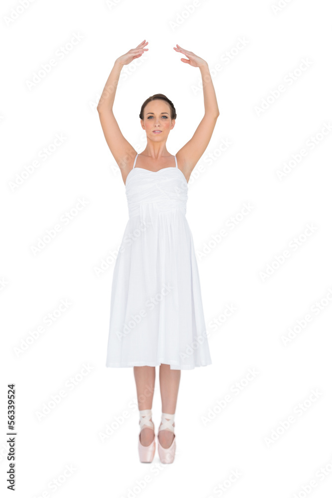 Focused young ballet dancer standing on her tiptoes Focused young ballet dancer standing on her tiptoes