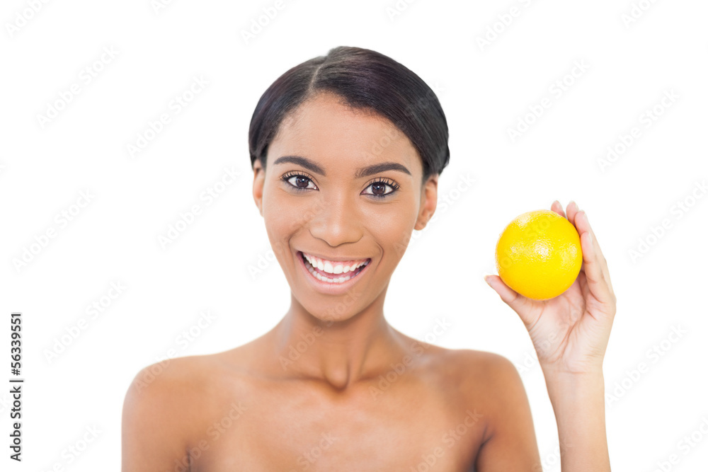 Smiling attractive model holding orange Smiling attractive model holding orange