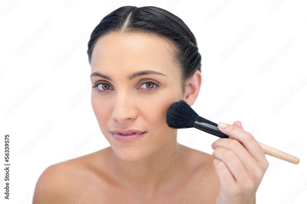 Gorgeous natural model applying makeup on her face Gorgeous natural model applying makeup on her face