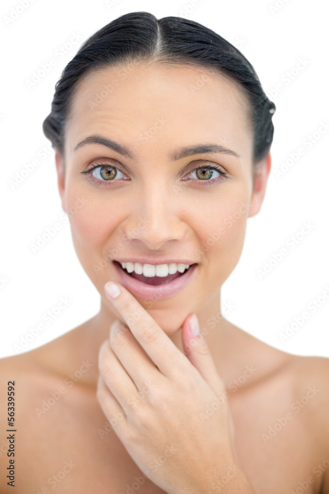 Smiling sensual model posing while touching her chin Smiling sensual model posing while touching her chin