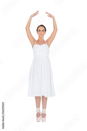 Focused young ballet dancer standing on her tiptoes