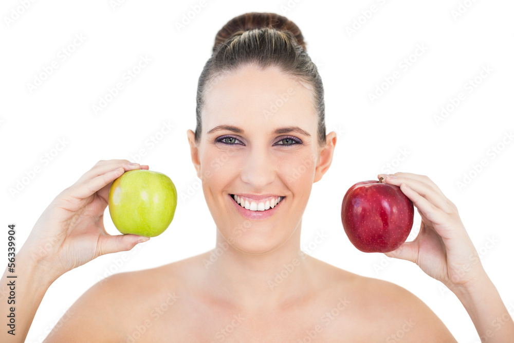 Smiling woman holding red and green apples Smiling woman holding red and green apples