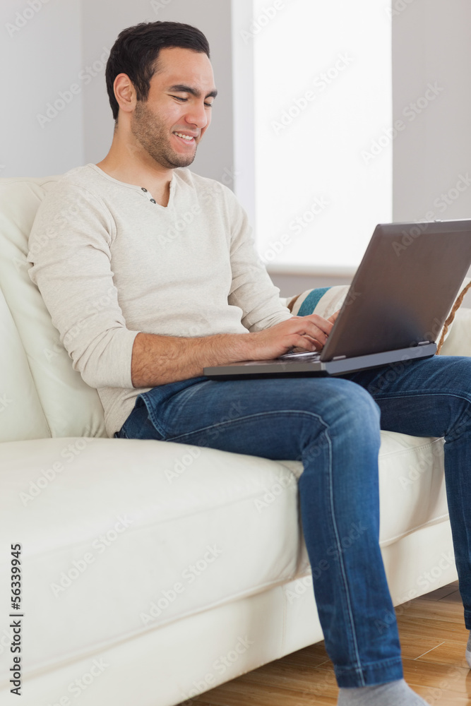 Smiling handsome man using his tablet computer Smiling handsome man using his tablet computer