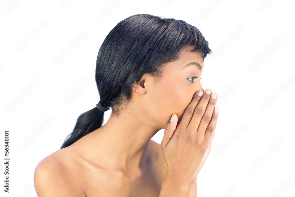 Attractive black haired woman covering her mouth with both hands Attractive black haired woman covering her mouth with both hands