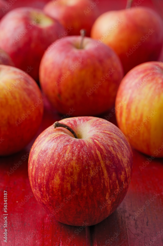 Apples on Red Wood. Vertical