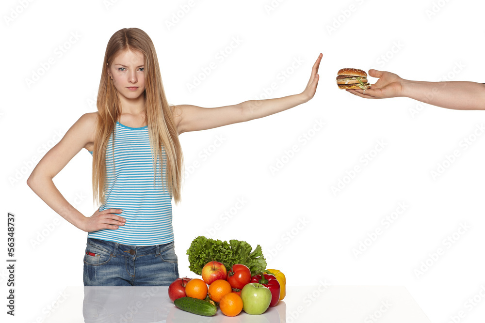 Serious young female refusing fast food Serious young female refusing fast food