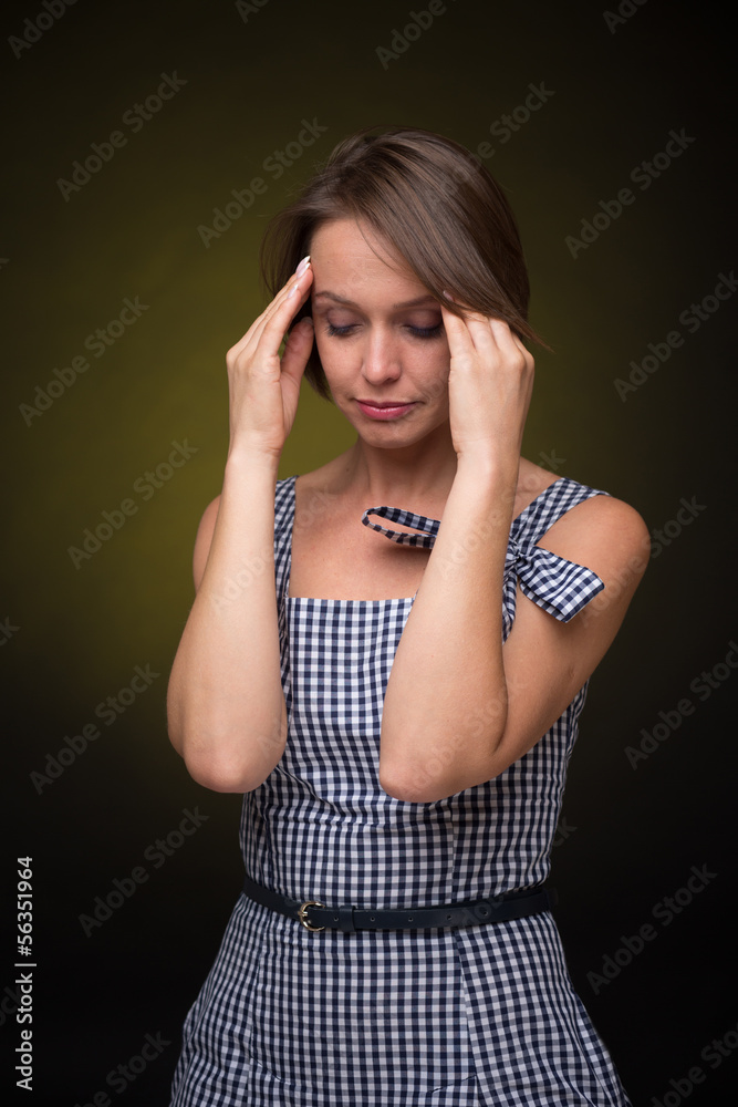 Beautiful woman with headache on golden-dark background Beautiful woman with headache on golden-dark background