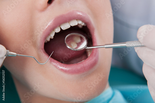 Patient at dentist office. Close-up of little girl sitting at th
