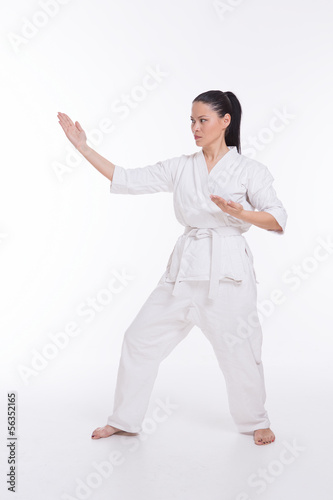 Beautiful woman in kimono show martial art exercise on white