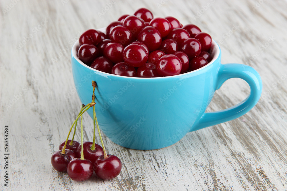 Sweet cherry in cup on table close-up Sweet cherry in cup on table close-up