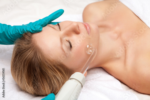 young woman and medical device touching her face