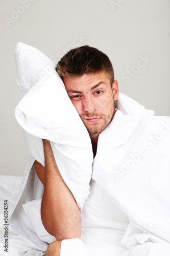 Handsome young man cant sleep in bed
