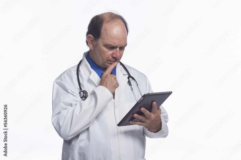 Doctor looking over results on his tablet, horizontal Doctor looking over results on his tablet, horizontal